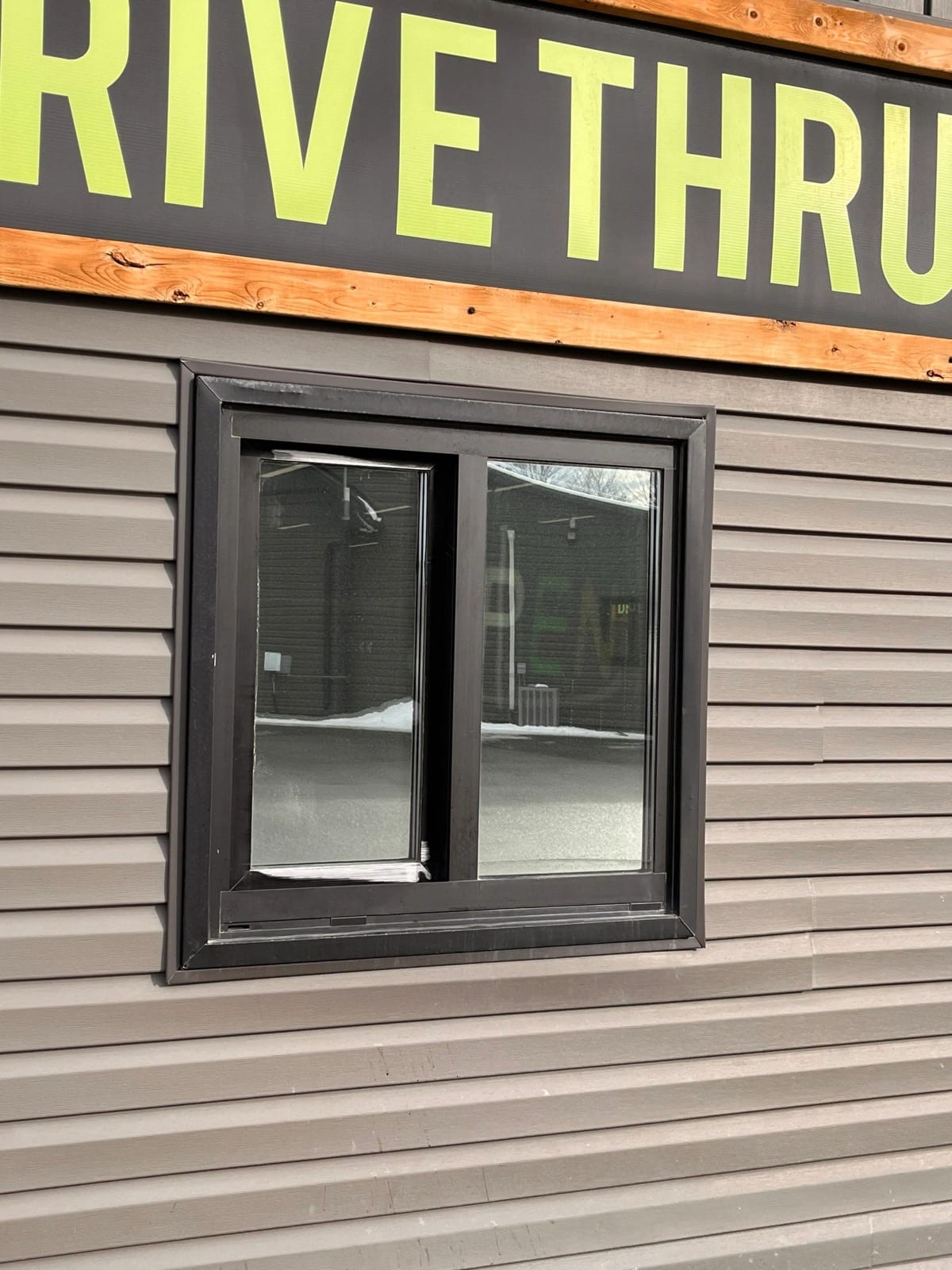 Drive-thru service window with dark film
