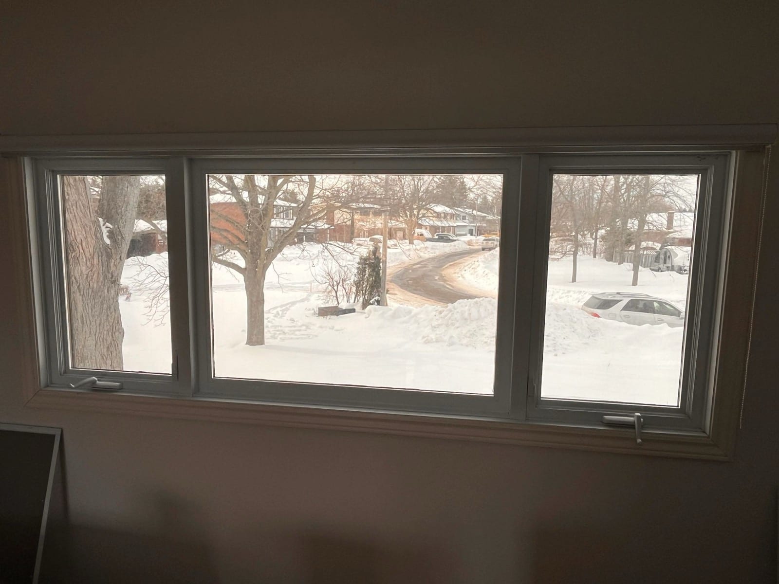 Interior view through filmed windows onto a snowy street